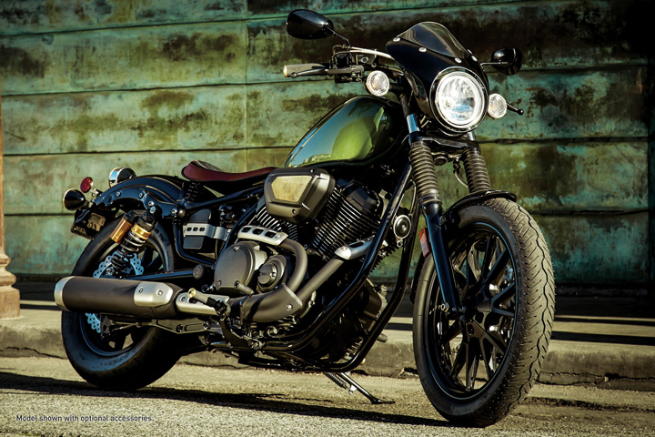 A closeup of a green cruiser motorcycle.